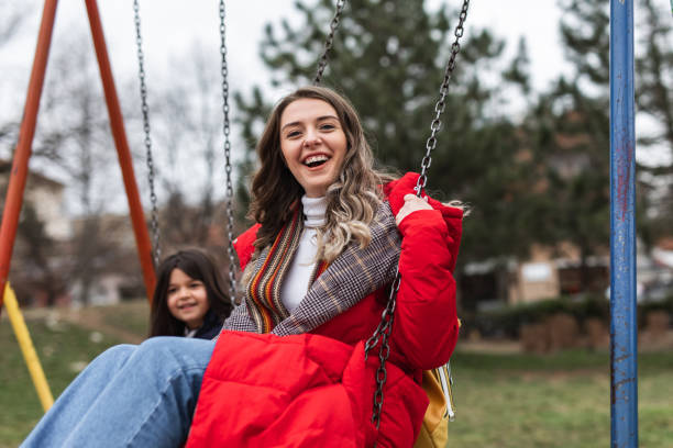 istock Swinging in public park with daughter is fun 1301611308
