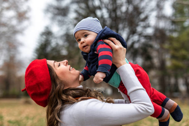 istock Smiling mom plays with son outdoor 1301612424