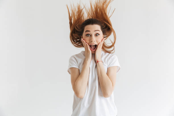istock Surprised woman in t-shirt holding her cheeks 1301612853