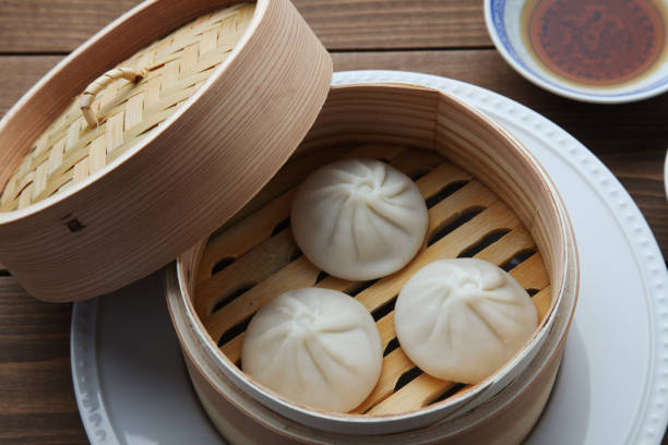 istock xiaolongbao Chinese steamed bun mantou dumpling on wooden table 1301613608