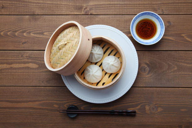 istock xiaolongbao Chinese steamed bun mantou dumpling on wooden table 1301613729