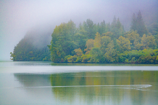 Morning fog on an autumn day, on cold waters of glacial Alaskan lake