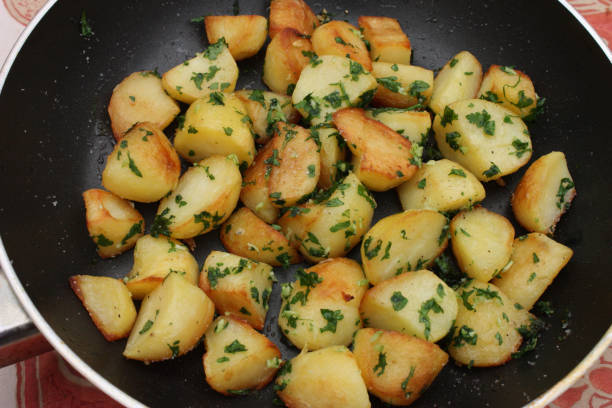 istock Hash browns being cooked with minced garlic and parsley 1301615515