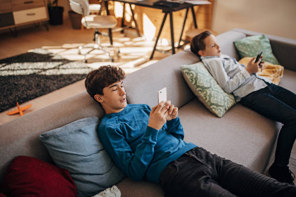istock Boys using smart phones at home 1301616865