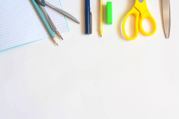 istock Stationery on a white background, notebook pens, pencils, compasses, eraser and scissors, flat lay, copy space, top view 1301619557