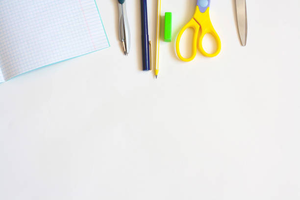 istock Stationery for education on a white background, notebook pen, pencil, compasses, eraser and scissors, flat lay, copy space 1301619560
