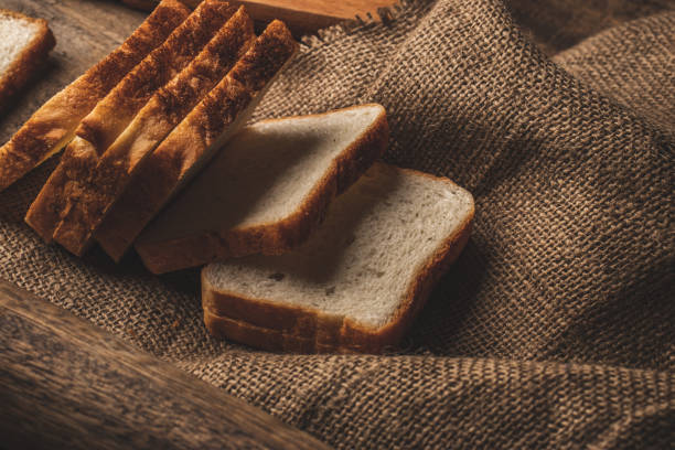 istock Sliced Bread stock image with wooden background. 1301619997
