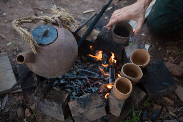 istock A steaming teapot and tea cups. Tea preparation in a clay pot on a fire. A camping trip, a journey. 1301620967