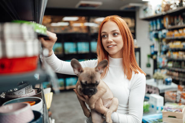 istock Woman in pet shop 1301621008