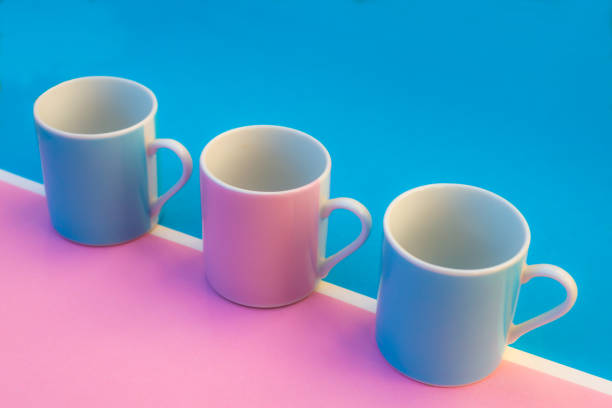 istock Pink and blue coffee cups on coloured background ,graphic image with bright colours. 1301621317