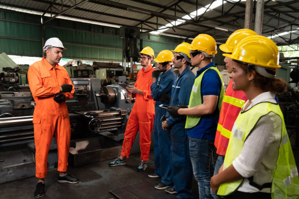istock Skillful worker attending brief meeting in the factory . 1301621587