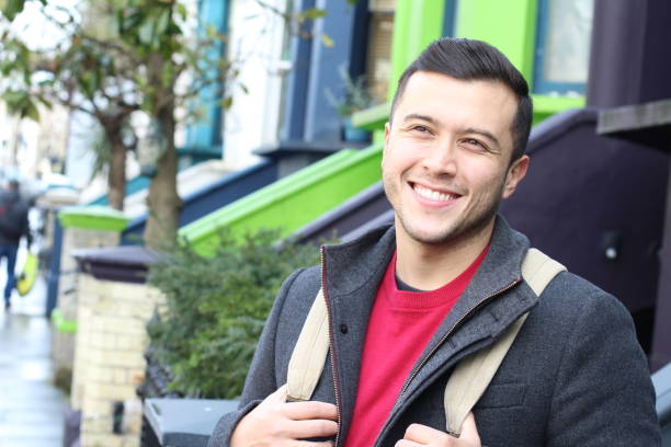 istock Mixed race person walking with backpack outdoors 1301622675