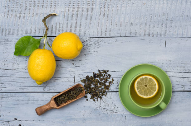 istock Ripe lemons and green cup of tea 1301623678
