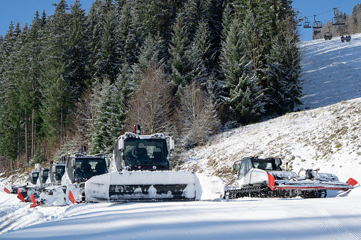 Snowplow machine at snowy ski resort. Modern snowcat ratrack. Snowcat vehicle. Snow tracks waiting. High quality photo