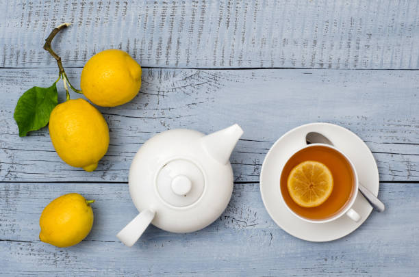 istock Ripe lemons, cup of tea and a teapot 1301623800