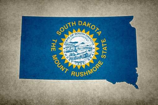 South Dakota flag on a flagpole waving in the wind, blue sky background. 3d illustration.