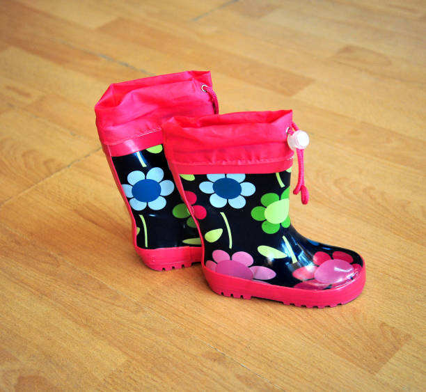 istock Small color children boots on wood background 1301624361