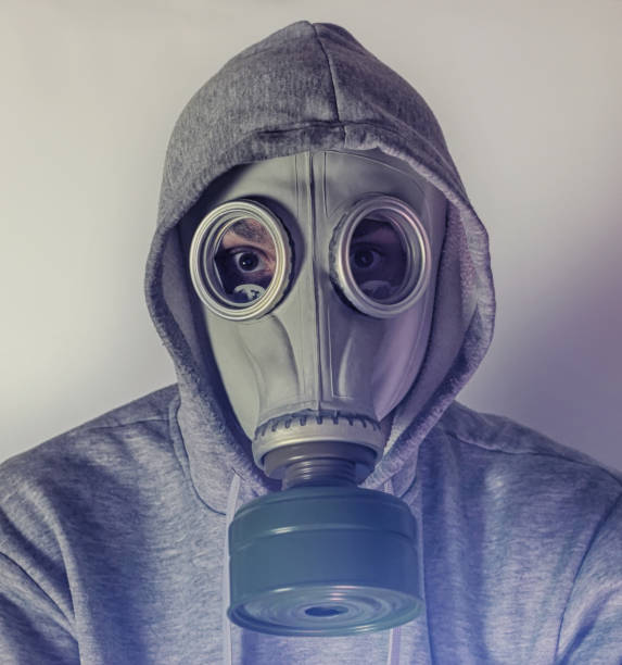 istock A man in a gas mask. Stalker. Sepia 1301625448