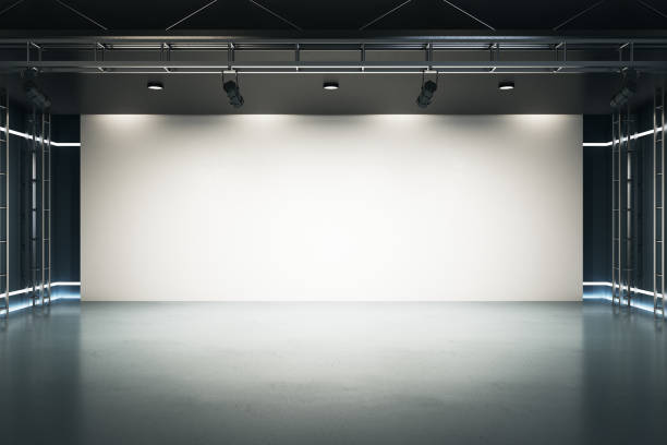 istock Big blank light screen instead of wall with projectors in empty industrial style hall room with glossy floor. Mockup. 3D rendering. 1301625857