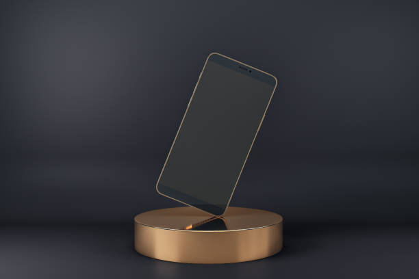 istock Blank black smartphone display standing on one corner on golden cylinder at abstract dark background. Realistic cell phone mockup. 3D rendering. 1301625924