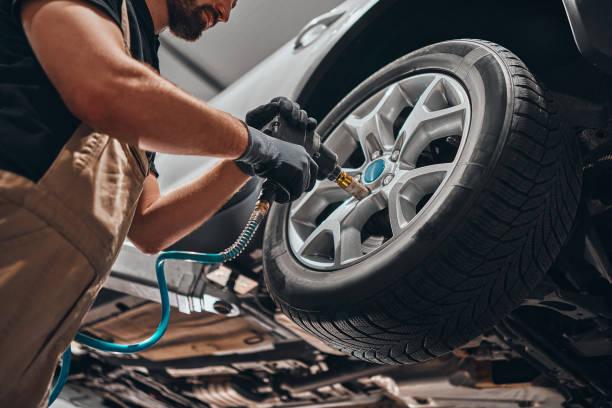 istock Auto mechanic changing car wheel. 1301626860