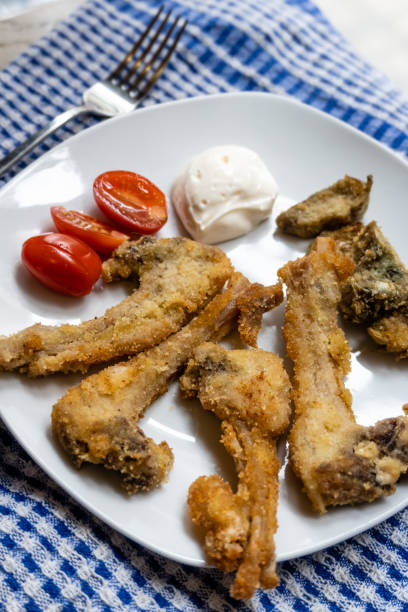 istock Breaded kid ribs, tomato and artichokes 1301627272