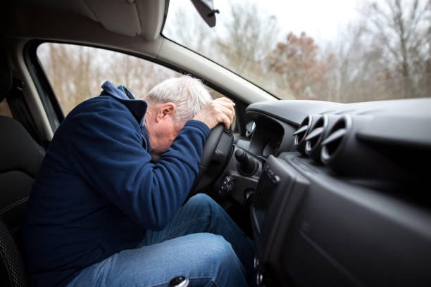 istock Man driving car and falling asleep at the wheel, transportation concept 1301628664