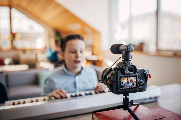 istock Boy musician playing synthesizer and vlogging 1301631366