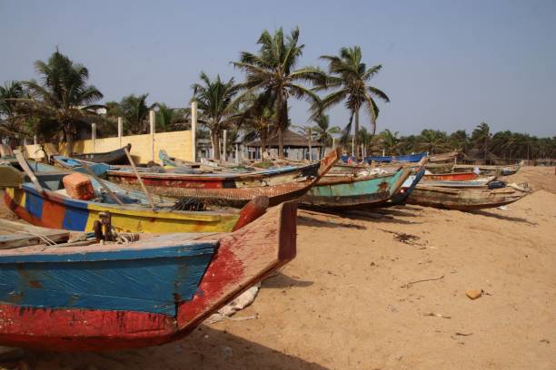 Colorful traditional fishing boats on the beach in Avepozo, Togo, West Africa. Avepozo, Togo - February 20, 2019: Colorful traditional fishing boats on the beach in Avepozo, Togo, West Africa. togo stock pictures, royalty-free photos & images