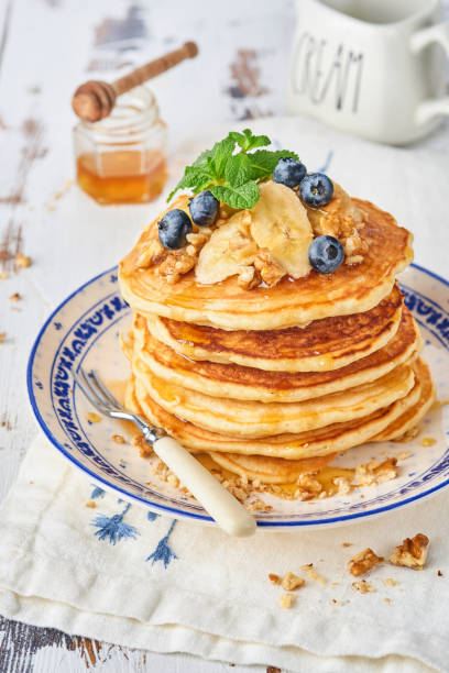 istock Pancakes with banana, walnut, honey and caramel for a breakfast. Selective focus. 1301632590