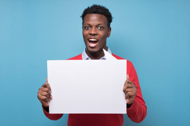 istock Handsome serious african business man presenting some product 1301632947