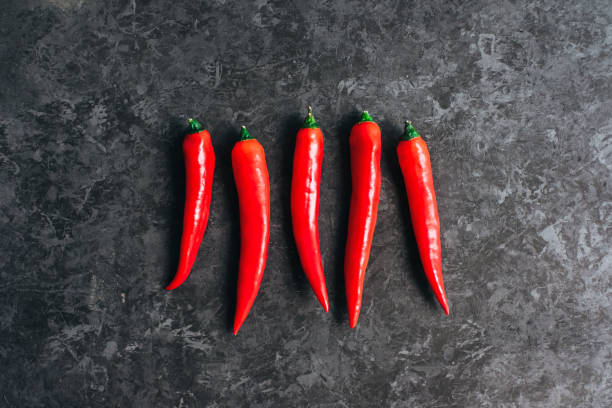 istock Red chili pepper isolated on black background, top view. 1301633149