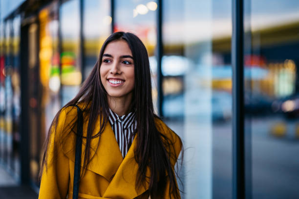 istock Young woman in yellow coat 1301633168