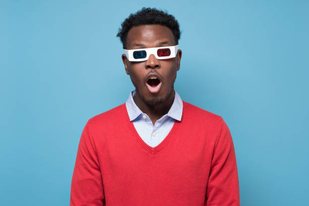 istock African man in 3D glasses being surprised watching interesting movie on screen 1301633246