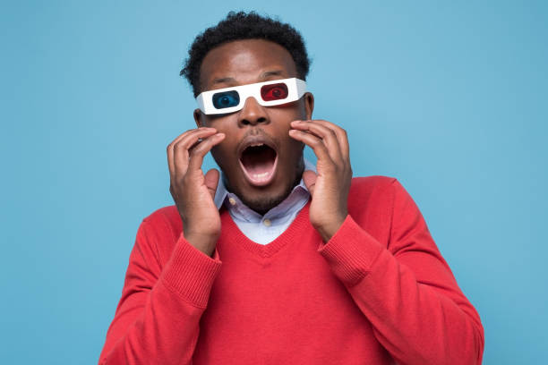 istock African man in 3D glasses being surprised watching interesting movie on screen 1301633893