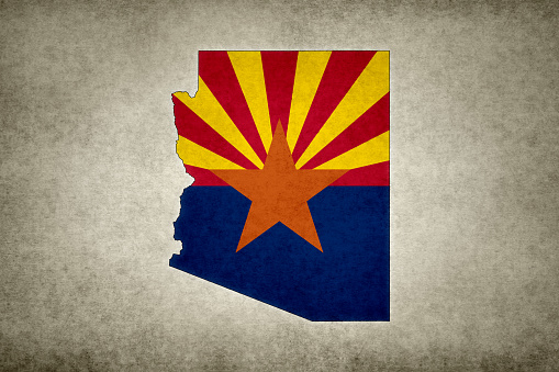 Grunge map of the state of Arizona (USA) with its flag printed within its border on an old paper.