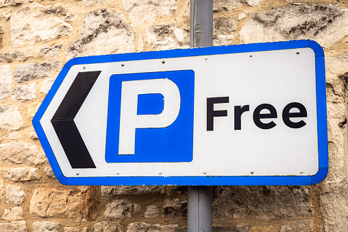 Close-up of a free parking sign in an English town.