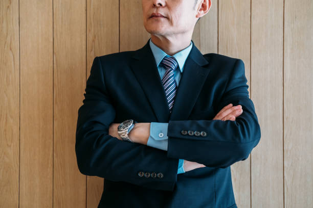 istock Unrecognizable businessman standing with arms crossed 1301639404