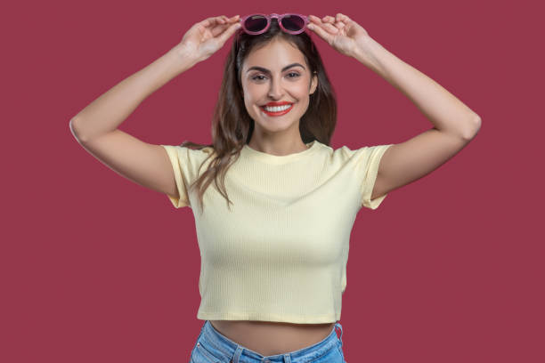 istock Smiling young pretty woman with hands near head 1301640655