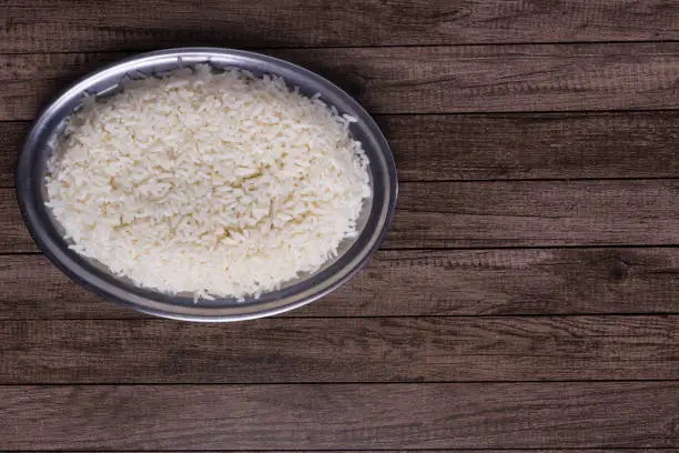 Photo of Cooked white rice. Horizontal gastronomic photography with space for texts. Popular food.
