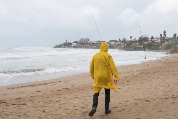 istock Fisherman surf fishing on the beach. 1301643993