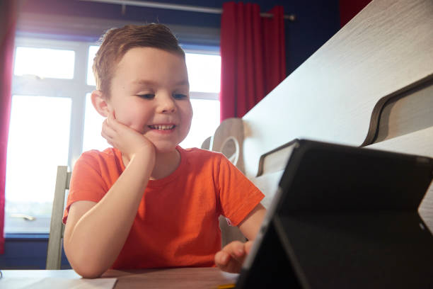 istock Happy young boy chatting with his teacher online 1301648277