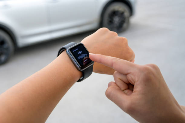 istock Female hands using smart watch to lock car 1301649080