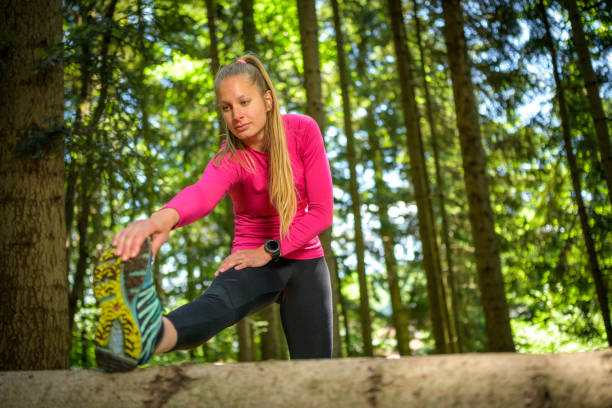 istock Young woman exercising in forest 1301649315