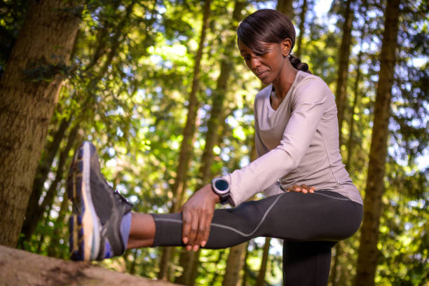 istock Woman exercising in forest 1301649447