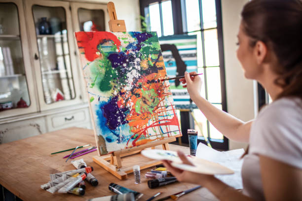 istock Young Female Artist Panting At Home 1301652243