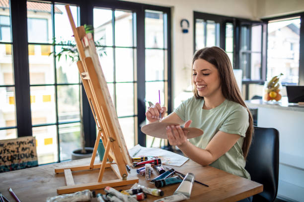 istock Young Female Artist Panting At Home 1301652745