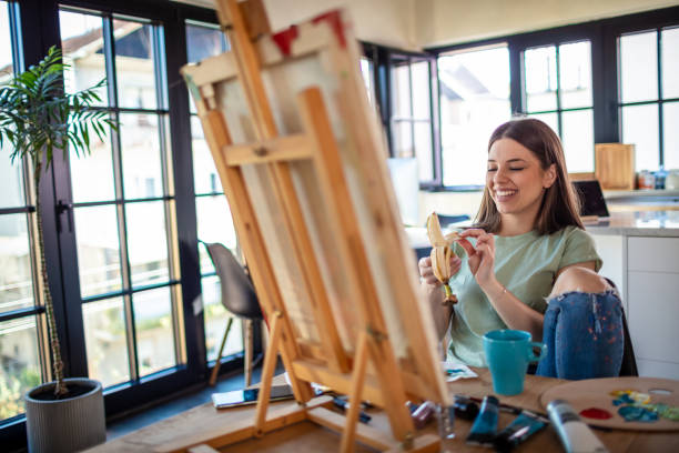 istock Young Female Artist Panting At Home 1301652934