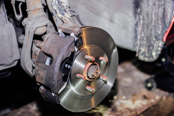 istock new brake disc mounted on an old rusty car 1301653100