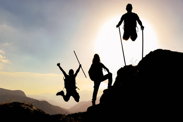 istock silhouette and enthusiasm of energetic, active and successful climbers 1301653161